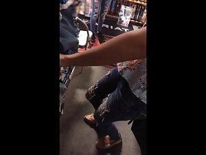 Cleavage of sexy store clerk in torn jeans Picture 3
