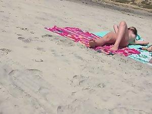 Sexy nudist friends caught while sunbathing on beach Picture 1