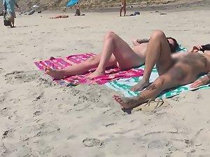 Sexy nudist friends caught while sunbathing on beach Picture 5