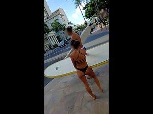 Petite surfer girl carries a heavy surfboard Picture 2