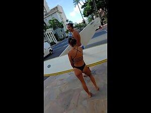 Petite surfer girl carries a heavy surfboard Picture 3