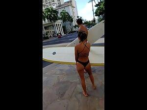 Petite surfer girl carries a heavy surfboard Picture 5