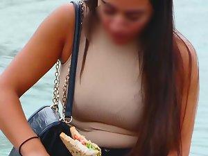 Busty cutie eating her lunch by a fountain Picture 2