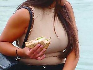 Busty cutie eating her lunch by a fountain Picture 3