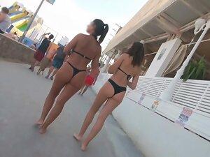 Two friends in thong bikinis walking by the beach Picture 1