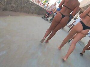 Two friends in thong bikinis walking by the beach Picture 5
