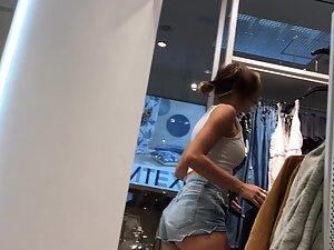 Sexy milf in tiny shorts is browsing the clothes store Picture 2