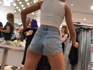 Sexy milf in tiny shorts is browsing the clothes store Picture 7