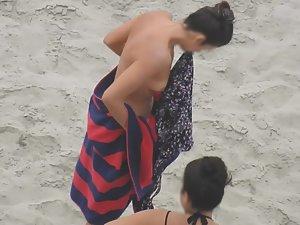 Beautiful woman gets dressed on beach Picture 3