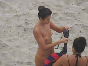 Beautiful woman gets dressed on beach Picture 4