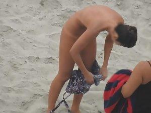 Beautiful woman gets dressed on beach Picture 6