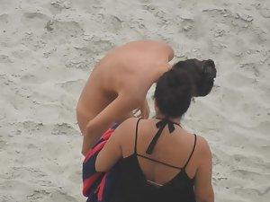 Beautiful woman gets dressed on beach Picture 7