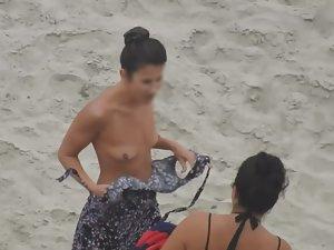 Beautiful woman gets dressed on beach Picture 8