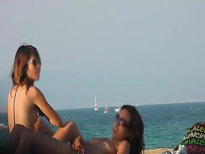 Voyeur notices lesbian girls on a beach Picture 3