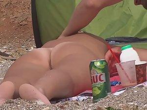 Nudist tries to finger his wife on beach Picture 1