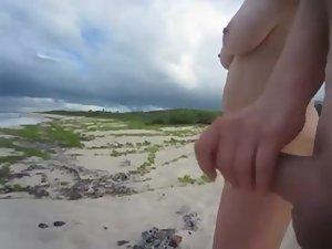 She yanks his dick on a deserted beach Picture 5