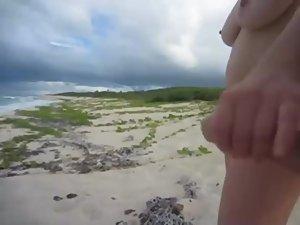 She yanks his dick on a deserted beach Picture 6