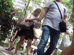 Upskirt of her juicy ass and lace thong while she is distracted by her phone Picture 1