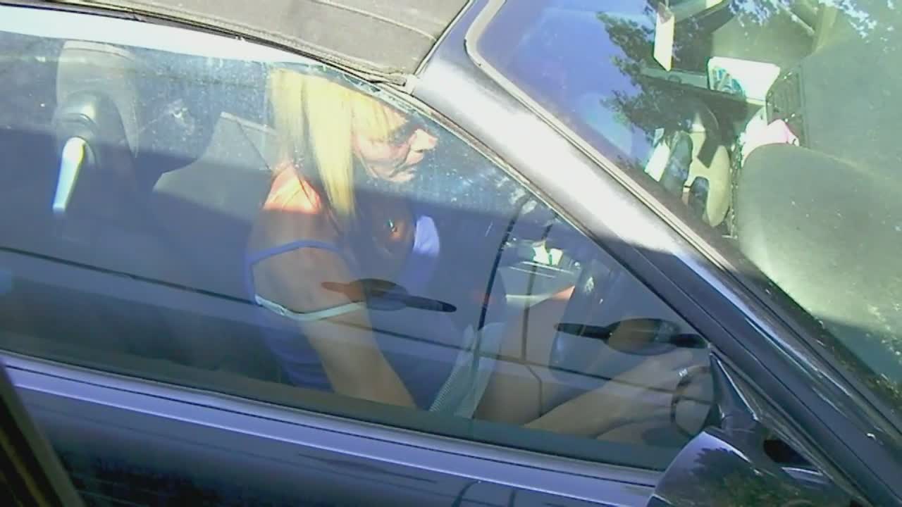 Upskirt of tattooed milf sitting in her