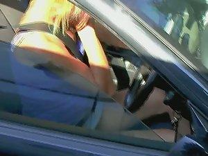 Upskirt of tattooed milf sitting in her car Picture 8