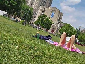Peeping on college girl sunbathing in park Picture 1