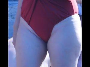 Meaty milf pussy barely fits inside a swimsuit Picture 3