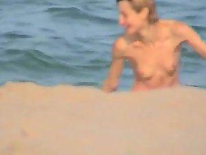 Skinny girl rushing out of the water