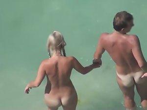 Naked couple stepping in the water Picture 2