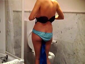 Delightful brunette changes clothes in bathroom Picture 7