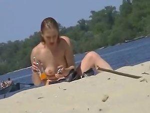 Cute topless girl smoking on a beach Picture 8
